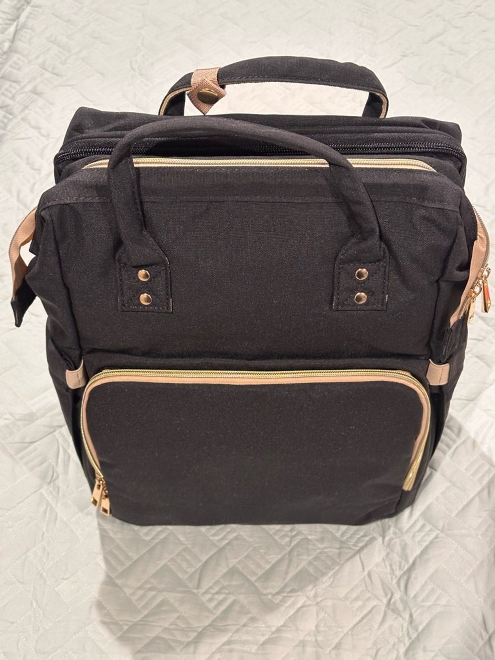 Multifunctional Diaper Bag Backpack with a Fold-Out Bassinet/Changing Station.